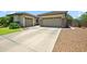 This home features a large driveway with a three-car garage for plenty of parking and easy access at 8417 W Northview Ave, Glendale, AZ 85305
