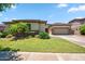 Charming single-story home featuring a well-manicured lawn, stone accents, and a spacious three-car garage at 8417 W Northview Ave, Glendale, AZ 85305