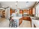 Bright kitchen with wood cabinetry, an island with bar seating, and tile floors at 8417 W Northview Ave, Glendale, AZ 85305
