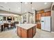 Spacious kitchen with a center island, seamless flow into dining and living areas, and ample storage at 8417 W Northview Ave, Glendale, AZ 85305