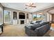 Inviting living room with a fireplace, built-in shelving, and a view of the outdoor pool at 8417 W Northview Ave, Glendale, AZ 85305
