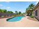 Backyard pool with tropical landscaping, rock accents, and privacy fence at 8417 W Northview Ave, Glendale, AZ 85305