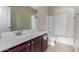 Bathroom featuring a vanity with cherry cabinetry, a sink, and a shower/tub combo at 865 E Del Rio St, Chandler, AZ 85225