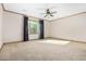 Spacious bedroom featuring a ceiling fan, neutral carpeting and large window at 865 E Del Rio St, Chandler, AZ 85225