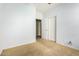 Bedroom with tan carpet and bi-fold closet doors, providing storage at 865 E Del Rio St, Chandler, AZ 85225