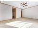Spacious bedroom featuring a ceiling fan, neutral carpeting and light trim at 865 E Del Rio St, Chandler, AZ 85225