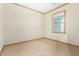 Bedroom features carpet floors, neutral paint, and a bright window with wood trim at 865 E Del Rio St, Chandler, AZ 85225