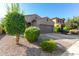 Single-story home with a desert-style landscape, two-car garage, and neutral exterior at 865 E Del Rio St, Chandler, AZ 85225