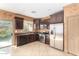 Well-lit kitchen featuring stainless steel appliances, dark cabinetry and access to the backyard at 865 E Del Rio St, Chandler, AZ 85225
