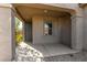 Cozy covered front porch entrance to the home with tiled flooring and neutral paint at 865 E Del Rio St, Chandler, AZ 85225