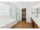 Bathroom featuring a soaking tub, separate shower, and vanity with modern fixtures and plenty of storage at 8758 W Myrtle Ave, Glendale, AZ 85305