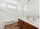 This bathroom features a tub and shower combo and wood cabinets at 8758 W Myrtle Ave, Glendale, AZ 85305
