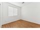 This cozy bedroom features laminate flooring and a large window at 8758 W Myrtle Ave, Glendale, AZ 85305