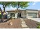 Inviting single-story home with neutral tones, desert landscaping, and a spacious two-car garage at 8758 W Myrtle Ave, Glendale, AZ 85305