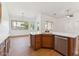 Bright kitchen boasts wood cabinets, stainless appliances, quartz countertops, and an eat-in dining area at 8758 W Myrtle Ave, Glendale, AZ 85305