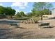 Unique playground sculpture on a sand base, surrounded by park benches and lush landscaping at 8758 W Myrtle Ave, Glendale, AZ 85305