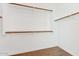 Empty walk-in closet with wood floors and plenty of storage space with built in shelving at 8758 W Myrtle Ave, Glendale, AZ 85305