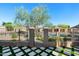 Beautifully landscaped backyard featuring turf squares, a fence, and a glimpse of the community pool at 8965 E Maple Dr, Scottsdale, AZ 85255