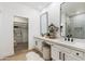 Bright bathroom featuring double vanity, modern mirrors, and a closet space at 8965 E Maple Dr, Scottsdale, AZ 85255