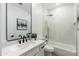 Modern bathroom with a sleek vanity, black hardware, and a shower-tub combo at 8965 E Maple Dr, Scottsdale, AZ 85255