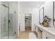 Well-lit bathroom boasts a glass-enclosed shower and a modern double vanity at 8965 E Maple Dr, Scottsdale, AZ 85255