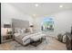 Spacious bedroom with a vaulted ceiling, large windows, and a cozy seating area at 8965 E Maple Dr, Scottsdale, AZ 85255