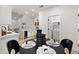 Modern dining area with a black table, seating for four, and view into kitchen at 8965 E Maple Dr, Scottsdale, AZ 85255