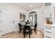 Cozy dining area with a black table, modern chairs, and view into the backyard at 8965 E Maple Dr, Scottsdale, AZ 85255
