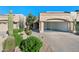 Attractive home exterior with a spacious driveway and desert-friendly landscaping at 8965 E Maple Dr, Scottsdale, AZ 85255