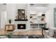 Bright living room features a stylish fireplace with decorative mantle and built in shelving at 8965 E Maple Dr, Scottsdale, AZ 85255