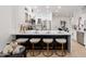 The gourmet kitchen features a marble island with seating, white cabinets, and stainless steel appliances at 8965 E Maple Dr, Scottsdale, AZ 85255