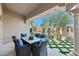 Inviting covered patio with stylish seating and a view of the manicured backyard at 8965 E Maple Dr, Scottsdale, AZ 85255