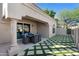 Charming outdoor patio area with elegant stone flooring and a lush, geometric turf design at 8965 E Maple Dr, Scottsdale, AZ 85255