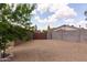 The backyard has mature trees and a gravel area, great for relaxation and landscaping at 929 W Knowles Cir, Mesa, AZ 85210