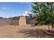 Backyard with a shed in a fully fenced yard and gravel area at 929 W Knowles Cir, Mesa, AZ 85210
