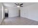 Bright bedroom with tile floors and a ceiling fan adjoins an ensuite bathroom and closet at 929 W Knowles Cir, Mesa, AZ 85210