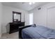 Bedroom with tile floors, ceiling fan, and a view of the attached mirrored dresser and closet at 929 W Knowles Cir, Mesa, AZ 85210