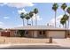 Charming single-story home featuring a well-maintained yard, palm trees, and an attached two-car garage at 929 W Knowles Cir, Mesa, AZ 85210