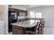Spacious kitchen featuring granite countertops, stainless steel appliances, and an island with barstool seating at 929 W Knowles Cir, Mesa, AZ 85210