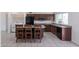 Open kitchen features granite countertops, dark cabinetry, and an island with barstool seating at 929 W Knowles Cir, Mesa, AZ 85210