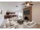 Cozy living room with a brick fireplace, open to the kitchen, and a sliding door to the backyard at 929 W Knowles Cir, Mesa, AZ 85210