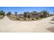 Inviting entrance to The Villages at Accomazzo with lush landscaping and clear signage at 9737 W Agora Ln, Tolleson, AZ 85353