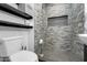 Modern bathroom featuring a tiled shower with niche, floating shelves and toilet at 1032 E Redfield Rd, Tempe, AZ 85283