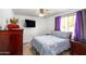Comfortable bedroom with soft lighting, a ceiling fan, and a window at 1032 E Redfield Rd, Tempe, AZ 85283