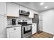 Updated kitchen with stainless steel appliances, granite countertops, and tile backsplash at 1032 E Redfield Rd, Tempe, AZ 85283
