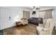 Cozy living room with hardwood floors, ceiling fan, and neutral paint tones at 1032 E Redfield Rd, Tempe, AZ 85283