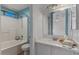 Well-lit bathroom with white vanity, tile flooring and shower-tub combo at 10646 E Enid Ave, Mesa, AZ 85208