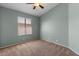 Cozy bedroom with green walls and natural light through window at 10646 E Enid Ave, Mesa, AZ 85208