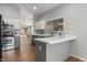 Modern kitchen with white cabinets, stainless steel appliances, and a breakfast bar at 10646 E Enid Ave, Mesa, AZ 85208