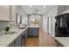Contemporary kitchen with gray cabinets, quartz countertops, and stainless steel appliances at 10646 E Enid Ave, Mesa, AZ 85208